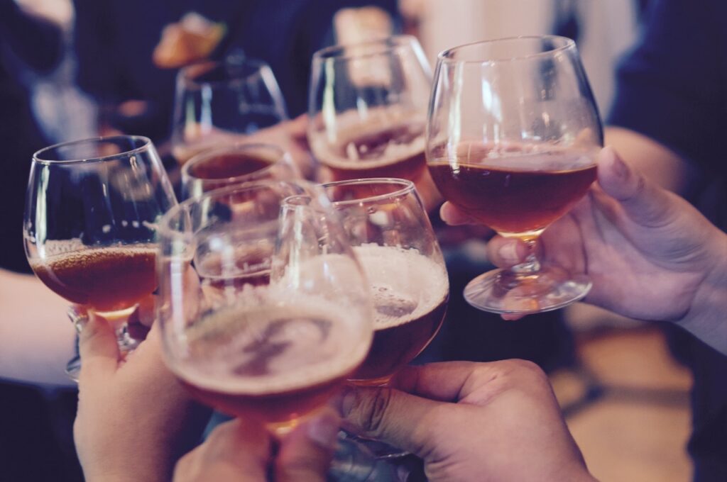 People cheers-ing with pint glasses full of beer