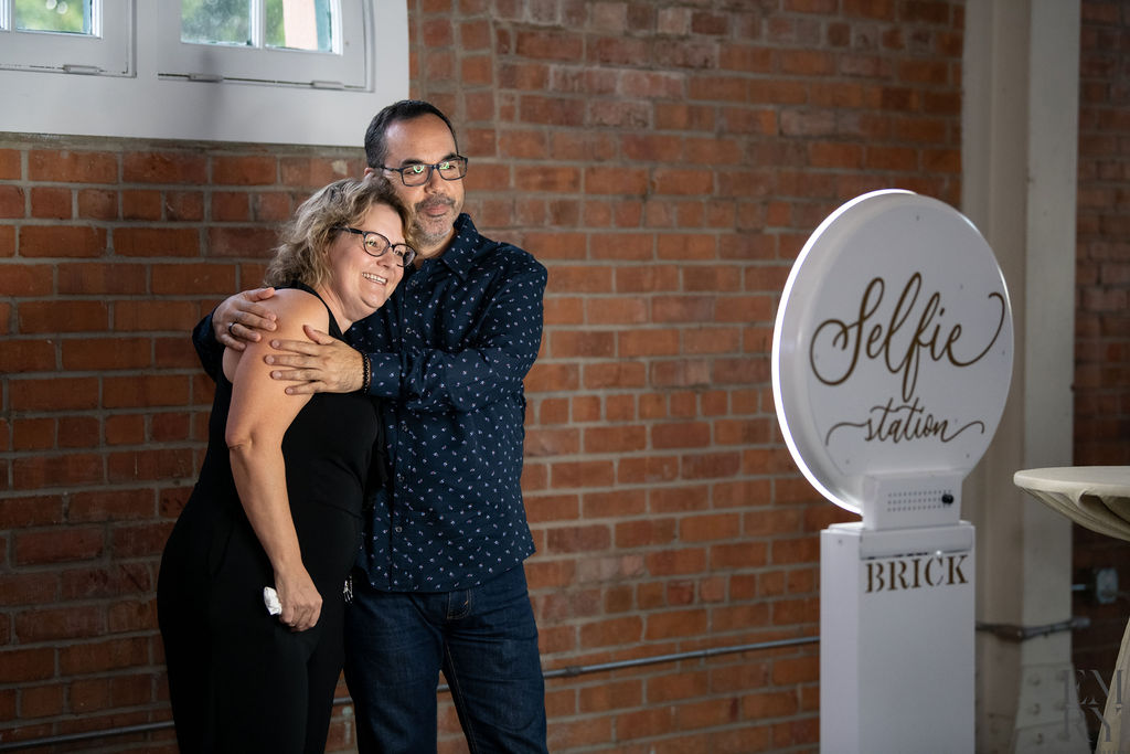 Guests taking a selfie at BRICK's photo booth