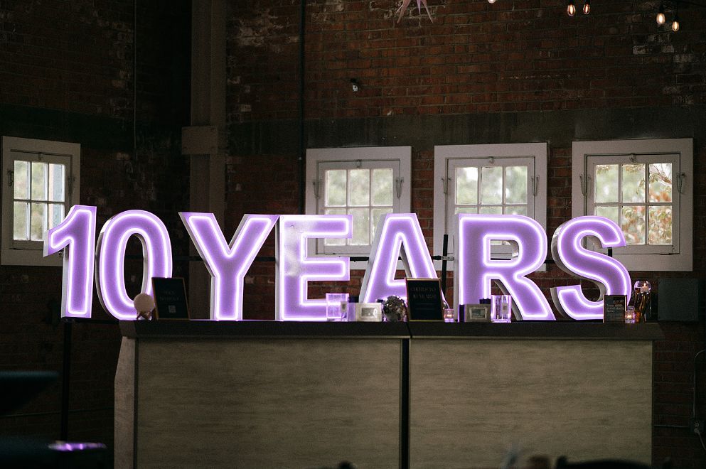 10 years neon sign behind bar