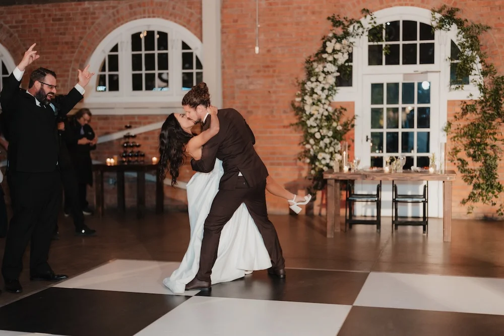 Bride and groom kissing and dancing on dance floor at BRICK