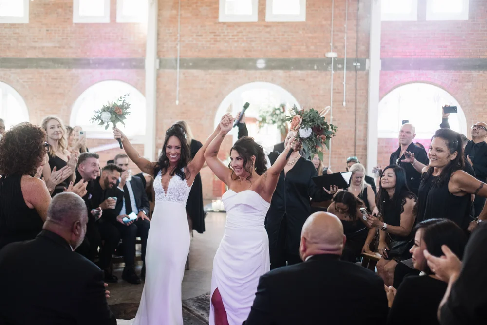 Two brides excited after their wedding ceremony at BRICK