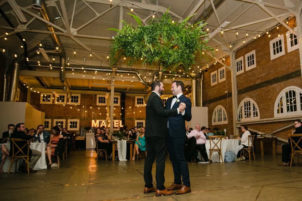Two grooms sharing their first dance