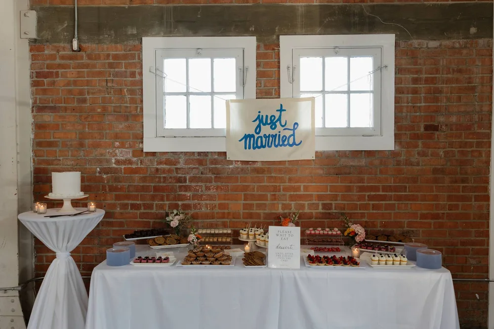 Dessert table with handmade Just Married sign above it at San Diego wedding at BRICK.