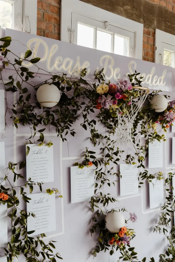 Close-up of a floral-adorned seating chart at a San Diego LGBTQ+ wedding at BRICK