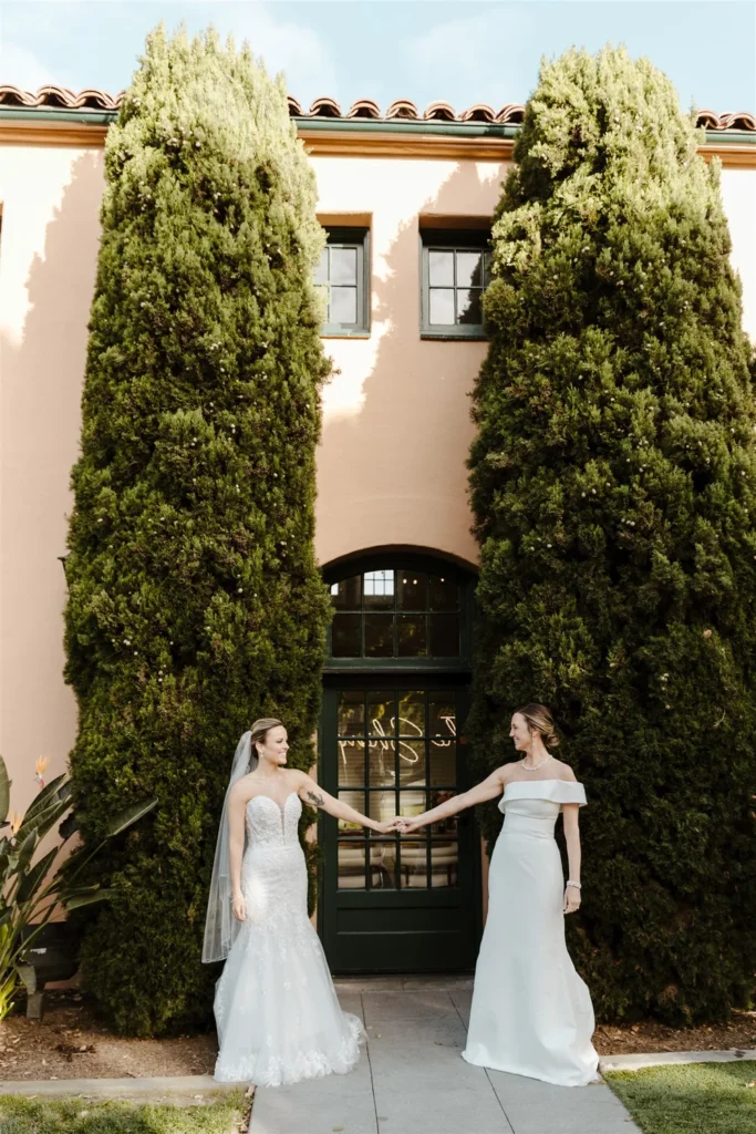 Brides smiling and holding hands outside of BRICK in San Diego, CA