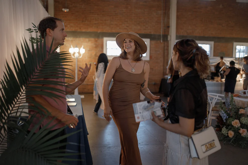 BRICK and 828 Planner, Cassidy, talking to guests at the open house