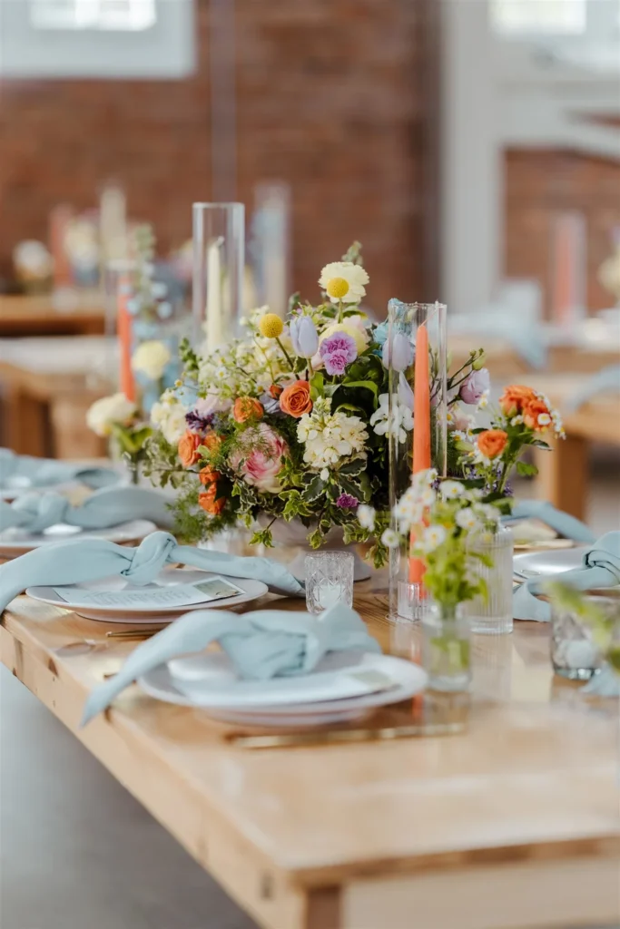 Wedding reception table styled with bright florals and candlelight for a San Diego wedding celebration